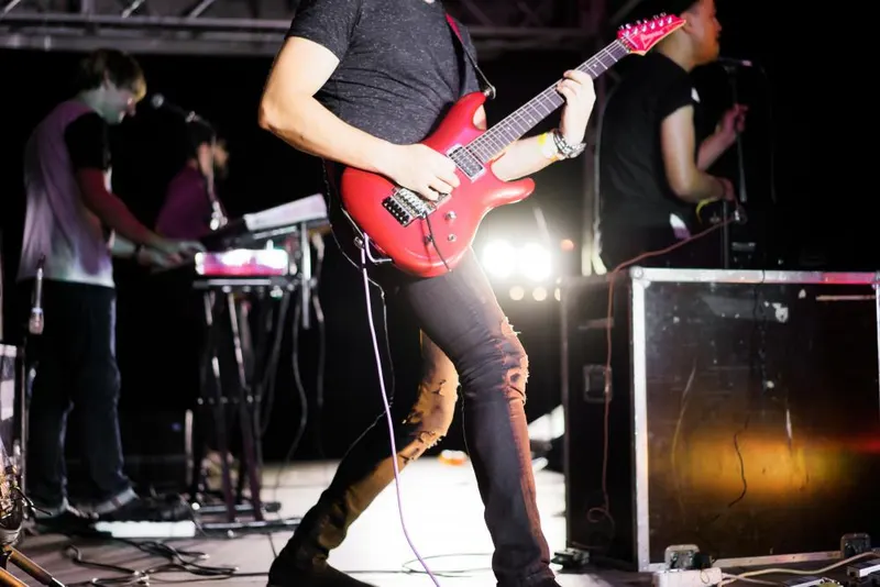 Guitarist performing on stage with a band