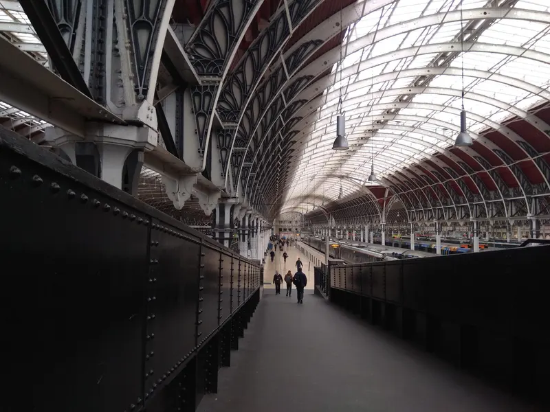 Interior of a long Victorian station arcade with a glazed roof